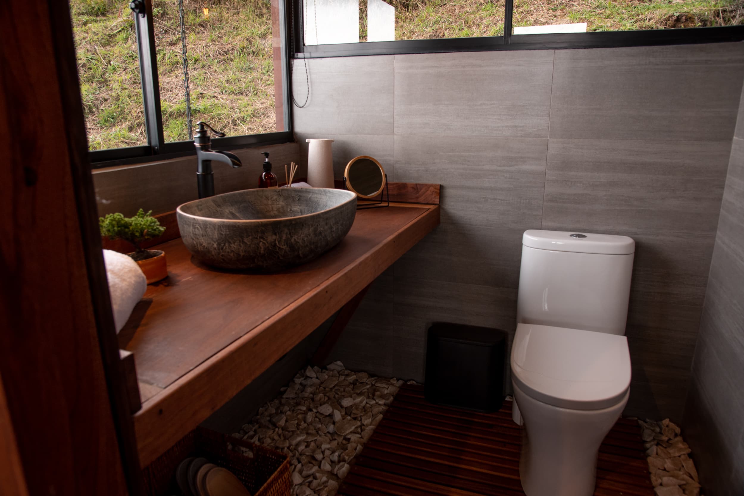 Stone vessel sink and wood bathroom